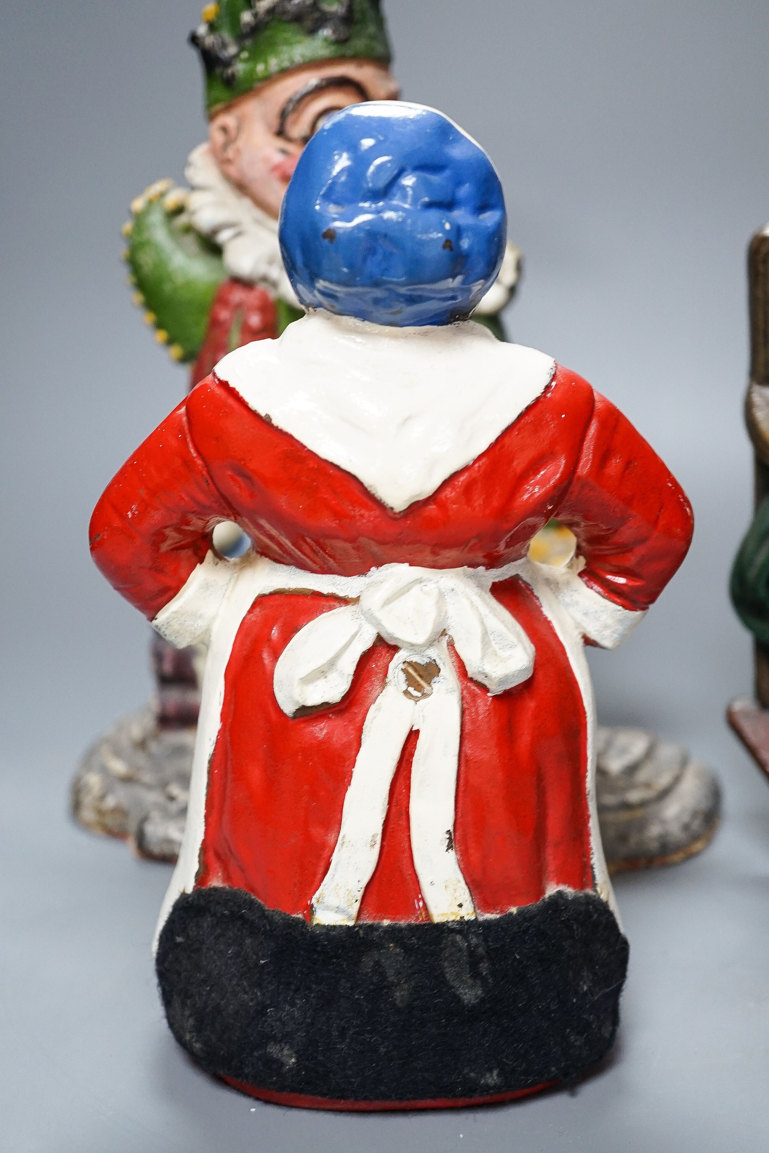 Three Victorian painted cast iron door stops (re-painted) 31cm and a later figure